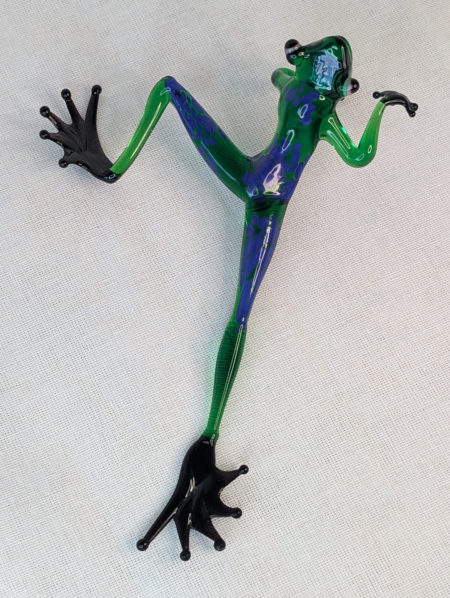 A green frog crawls .