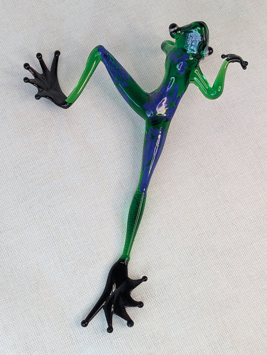 A green frog crawls .