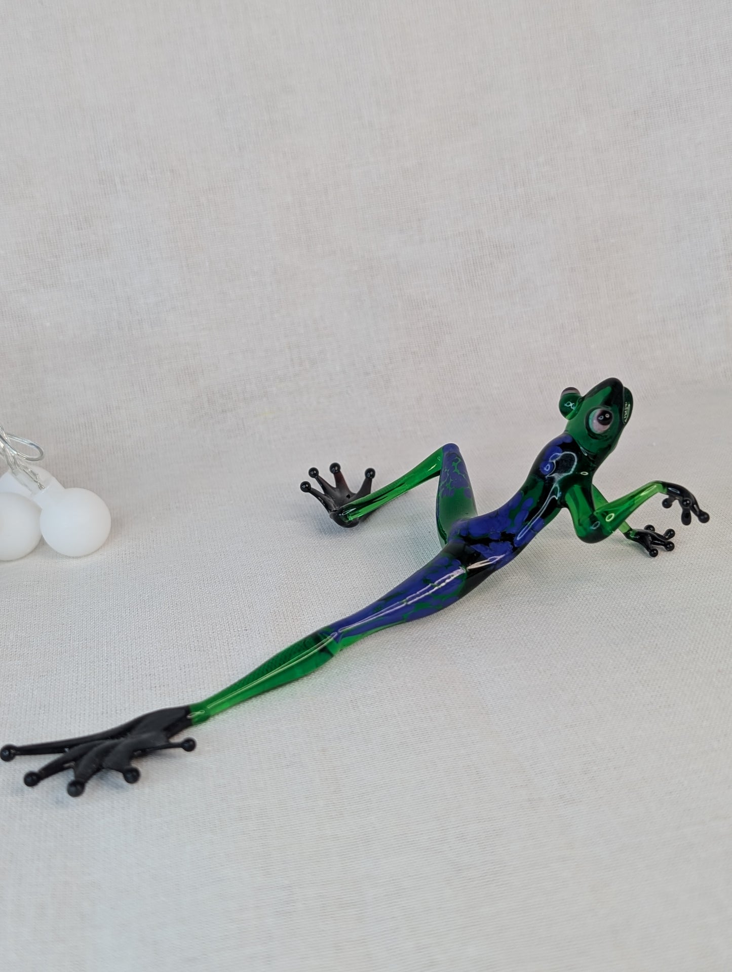 A green frog crawls .