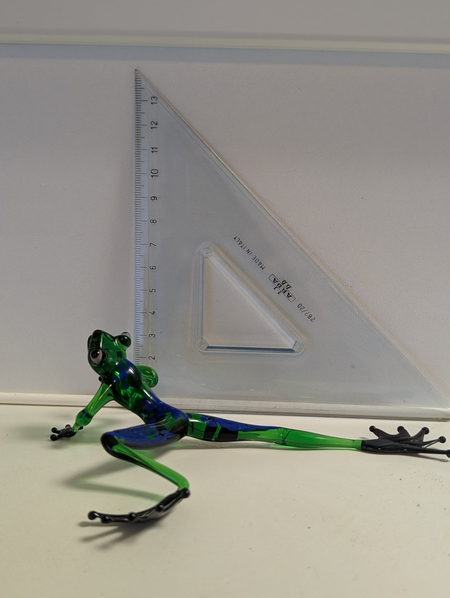 A green frog crawls .